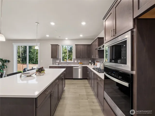 a kitchen with kitchen island granite countertop a sink and counter top space