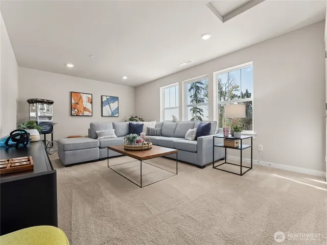 a living room with furniture and a large window