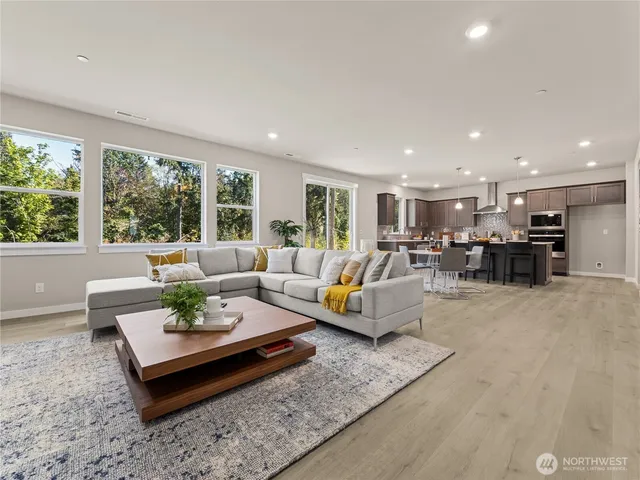 a living room with furniture kitchen view and a table