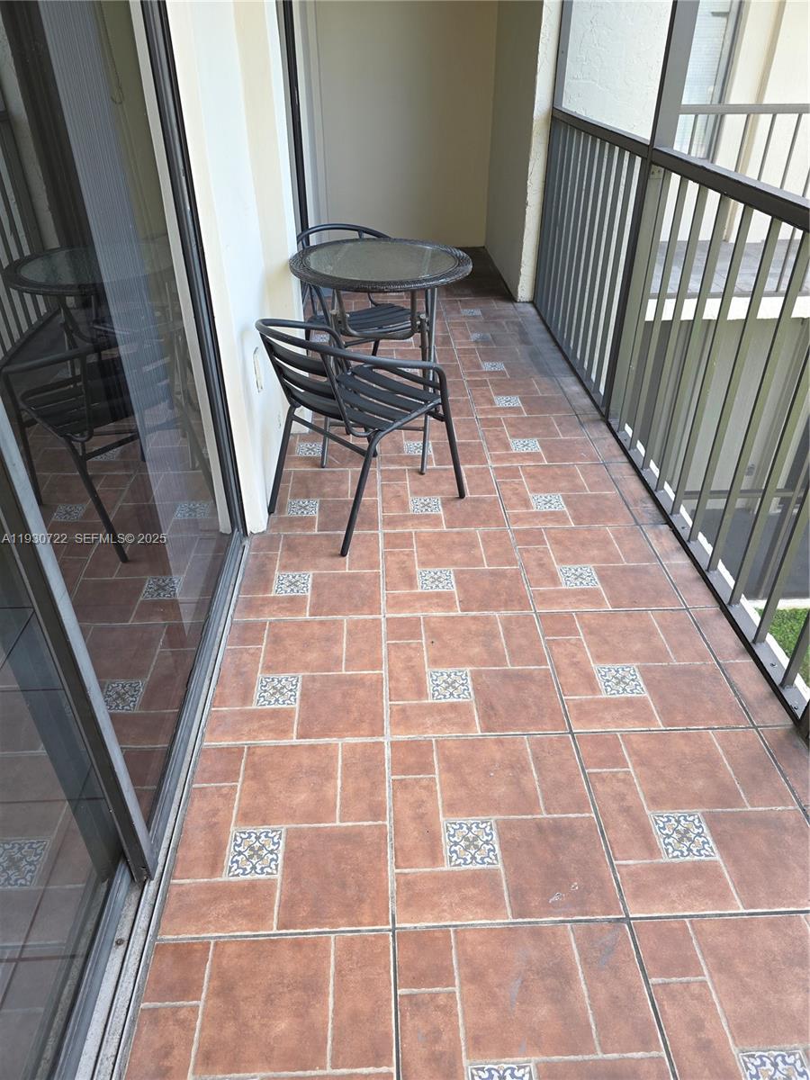 8075 Southwest 107th Avenue, Unit 210 Miami, FL 33173 - Photo 14 of 33 SCREENED BALCONY WITH ACCESS FROM LIVING ROOM AND MASTER BEDROOM