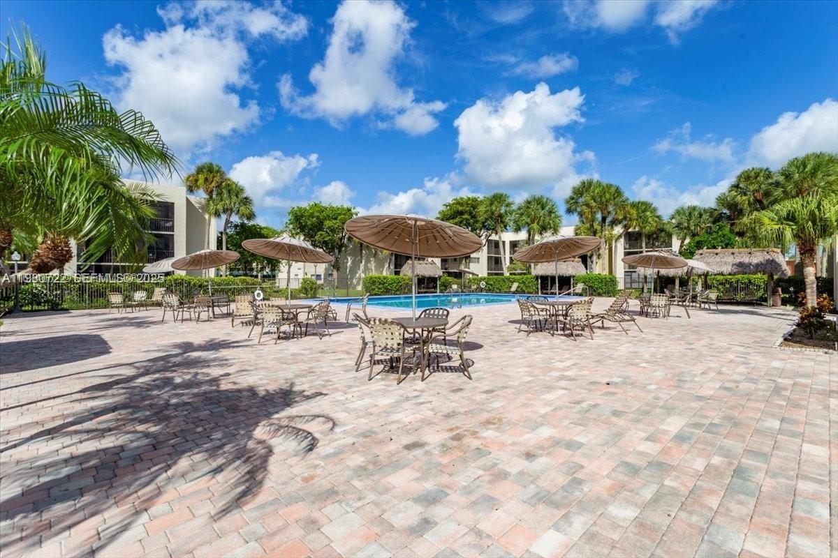 8075 Southwest 107th Avenue, Unit 210 Miami, FL 33173 - Photo 18 of 33 a view of a patio with swimming pool