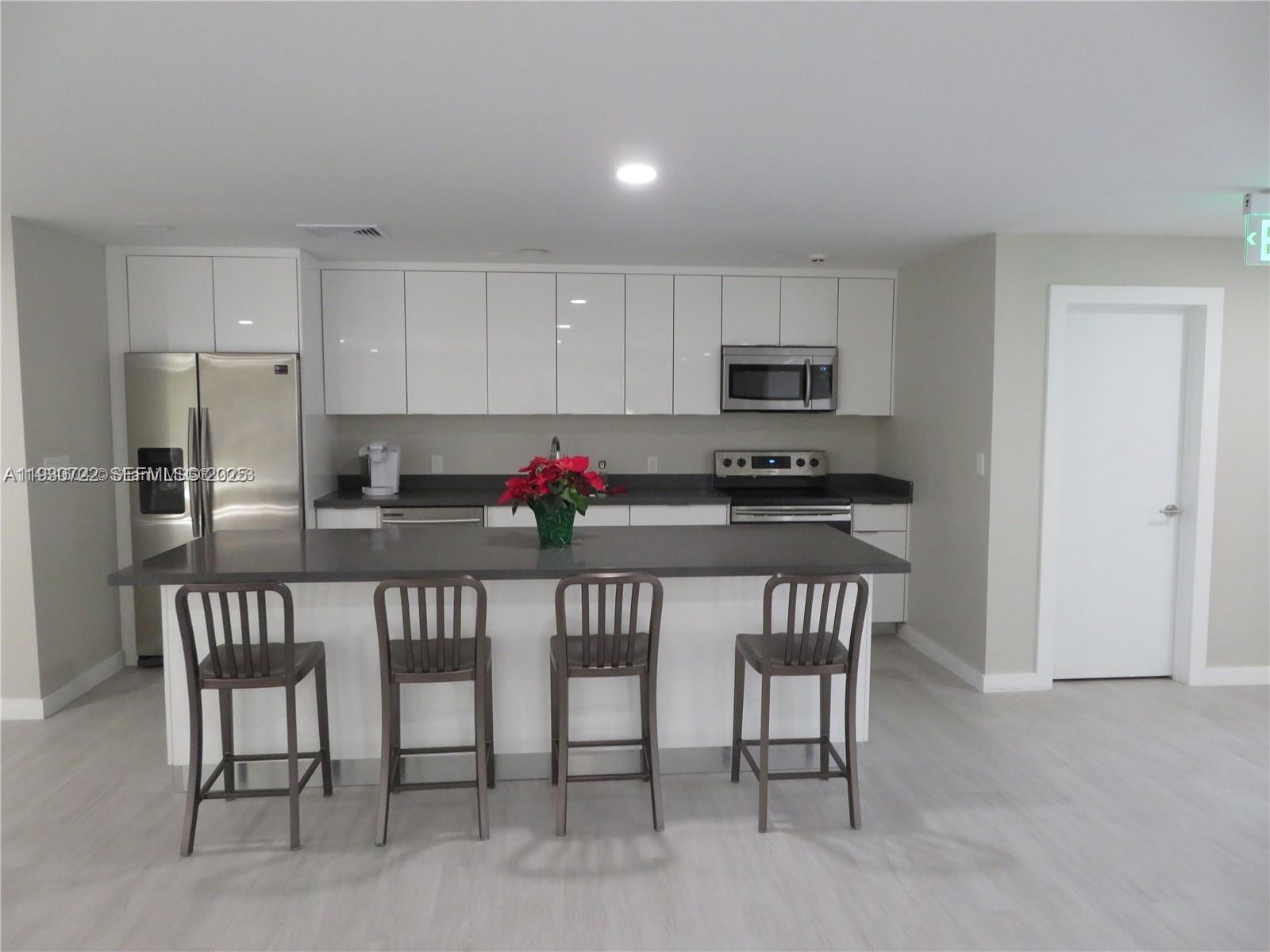 8075 Southwest 107th Avenue, Unit 210 Miami, FL 33173 - Photo 26 of 33 a kitchen with a dining table and refrigerator