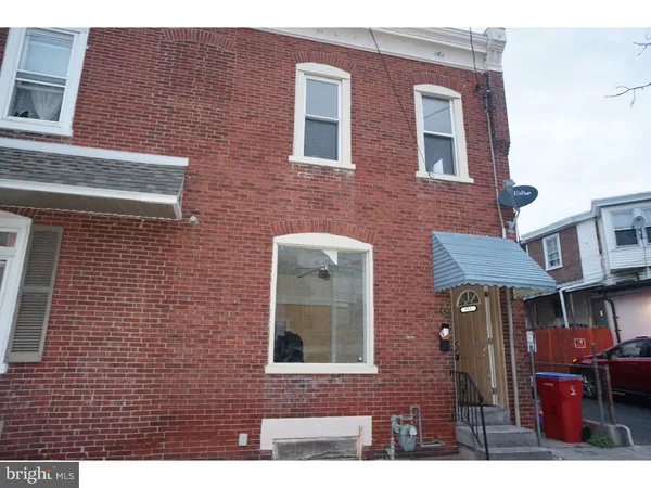 a front view of a building with brick walls