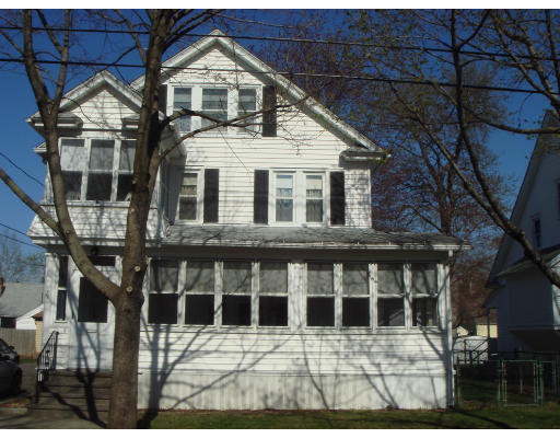 77 Sunapee Street Springfield, MA 01108 - Photo 28 of 28 a view of a white house with large windows and a small yard