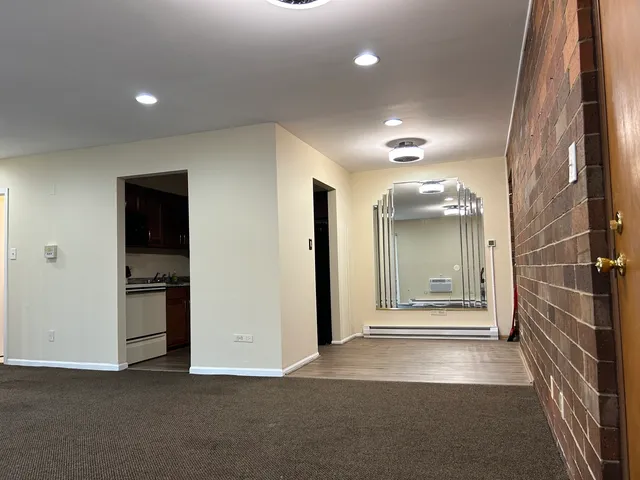 an empty room with entrance and windows