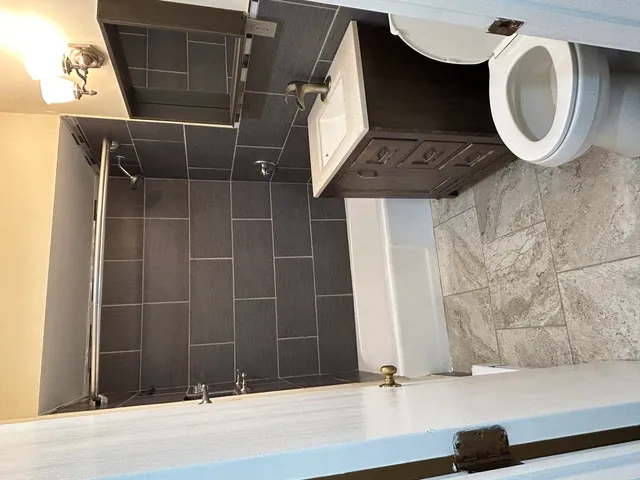 an empty room with a window and a ceiling fan