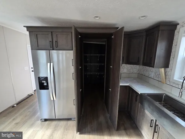 a kitchen with stainless steel appliances a refrigerator and cabinets