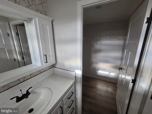 a bathroom with a sink and mirror