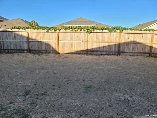 a view of an empty room with a kitchen