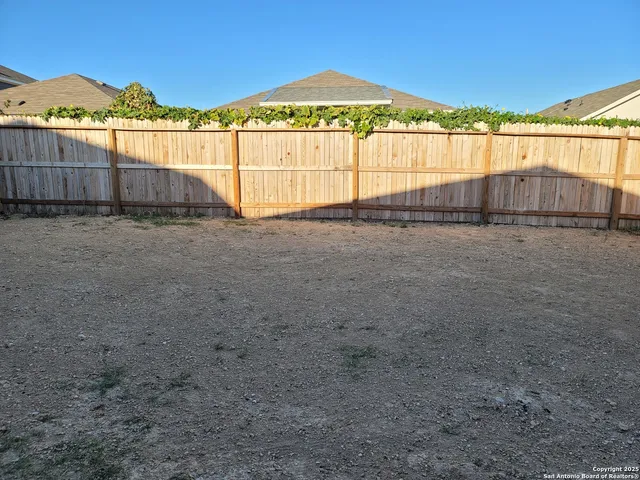 a view of an empty room with a kitchen