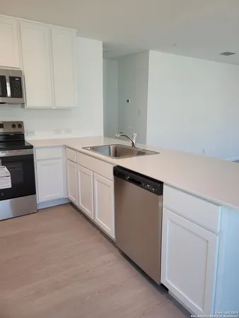 a kitchen with a sink and cabinets