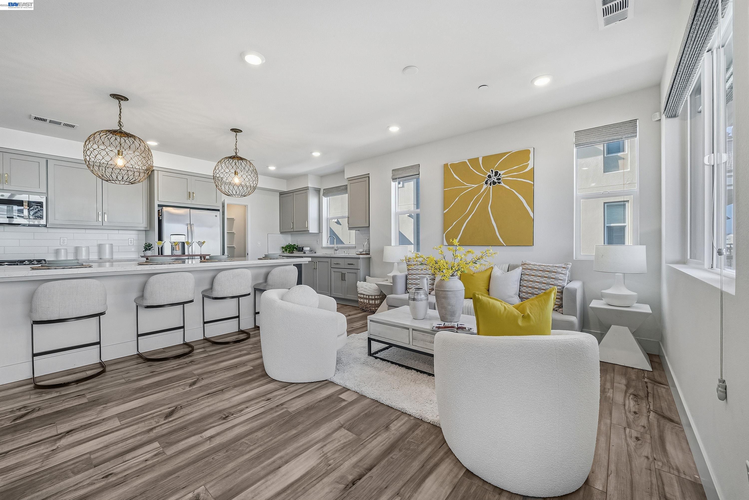 a living room with kitchen island furniture and a large window