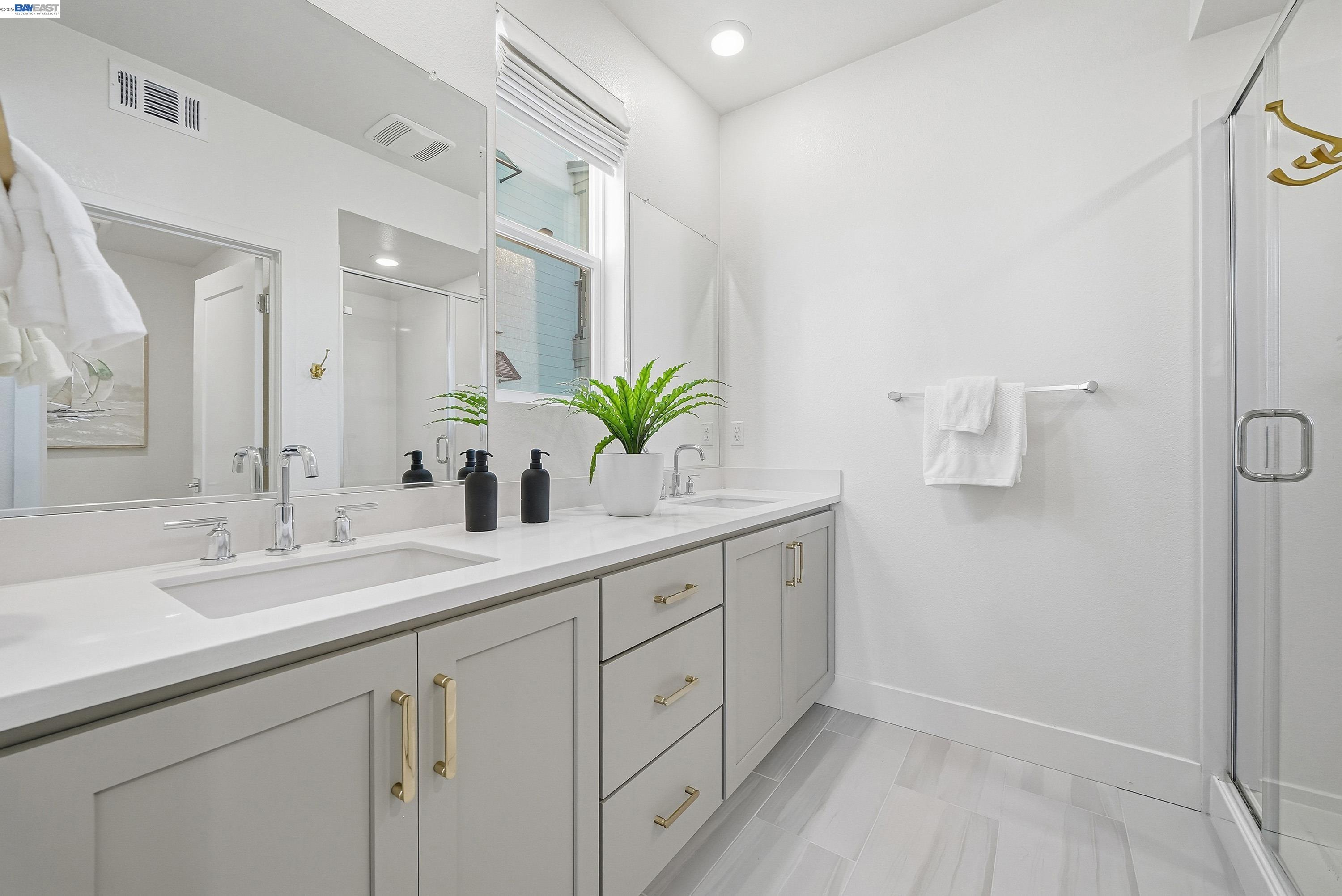 9620 Seawind Way Newark, CA 94560 - Photo 13 of 55 a bathroom with a sink a mirror and a potted plant