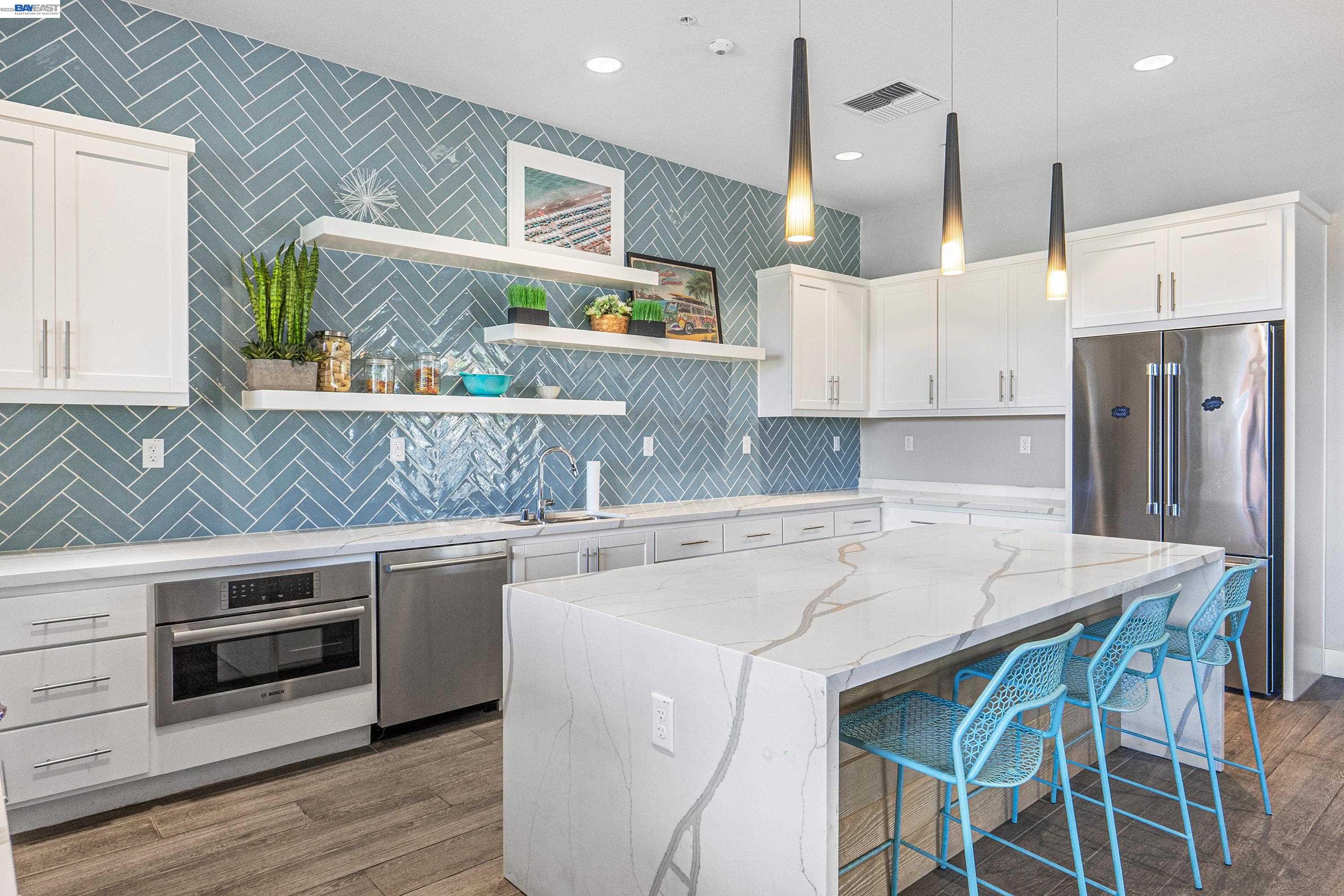9620 Seawind Way Newark, CA 94560 - Photo 35 of 55 a kitchen with stainless steel appliances granite countertop a sink a stove a refrigerator and island with wooden floor