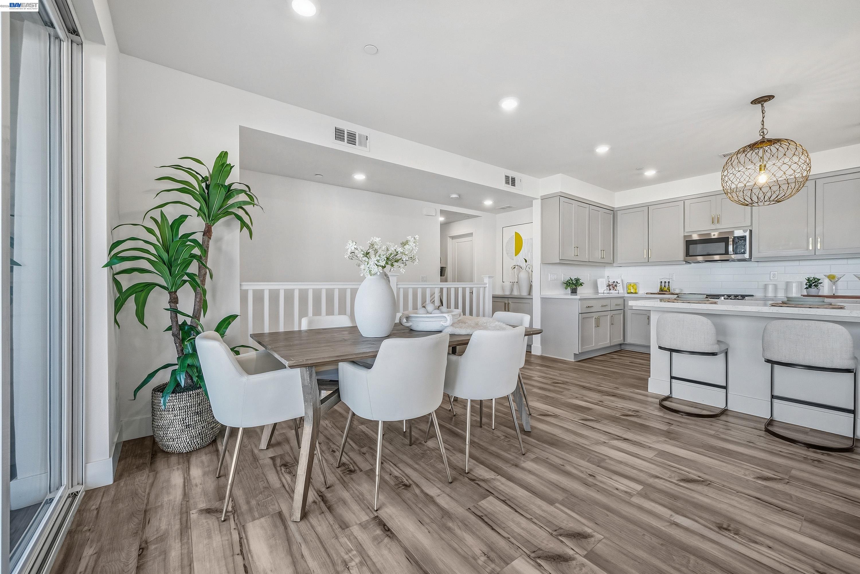 9620 Seawind Way Newark, CA 94560 - Photo 44 of 55 a view of a dining room with furniture and wooden floor
