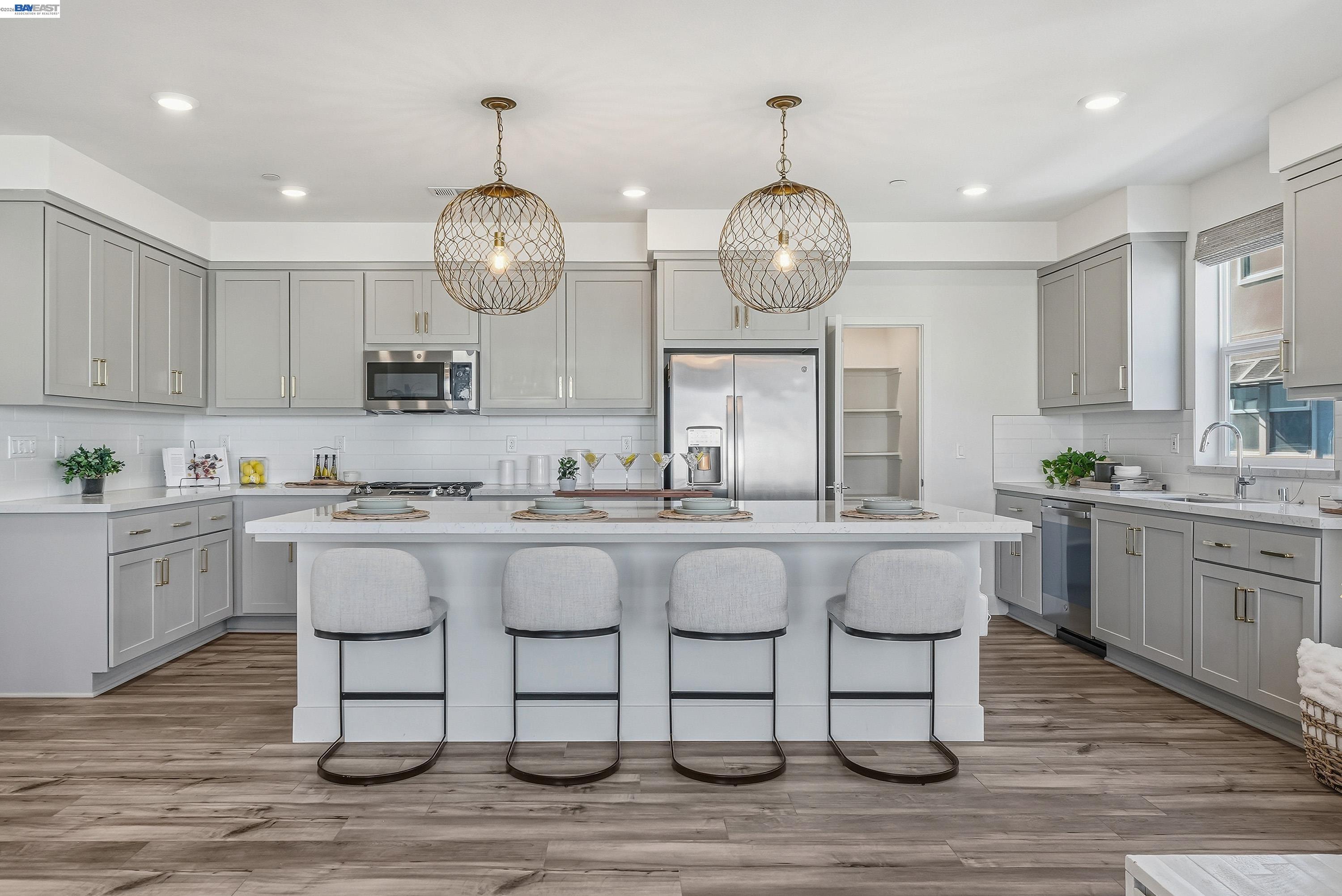 9620 Seawind Way Newark, CA 94560 - Photo 45 of 55 a kitchen with center island cabinets and wooden floor
