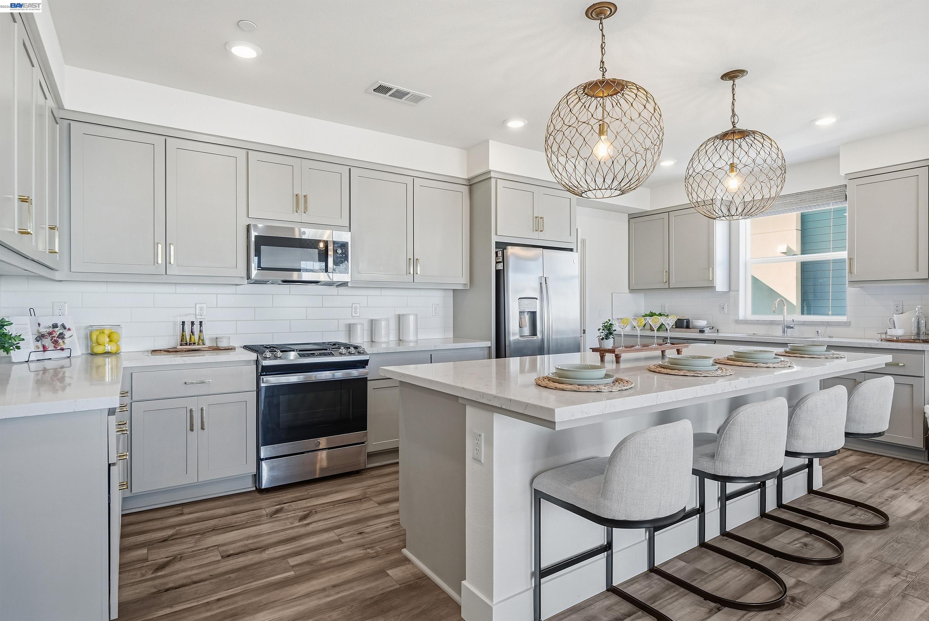 9620 Seawind Way Newark, CA 94560 - Photo 46 of 55 a kitchen with kitchen island granite countertop stainless steel appliances a stove a sink and cabinets