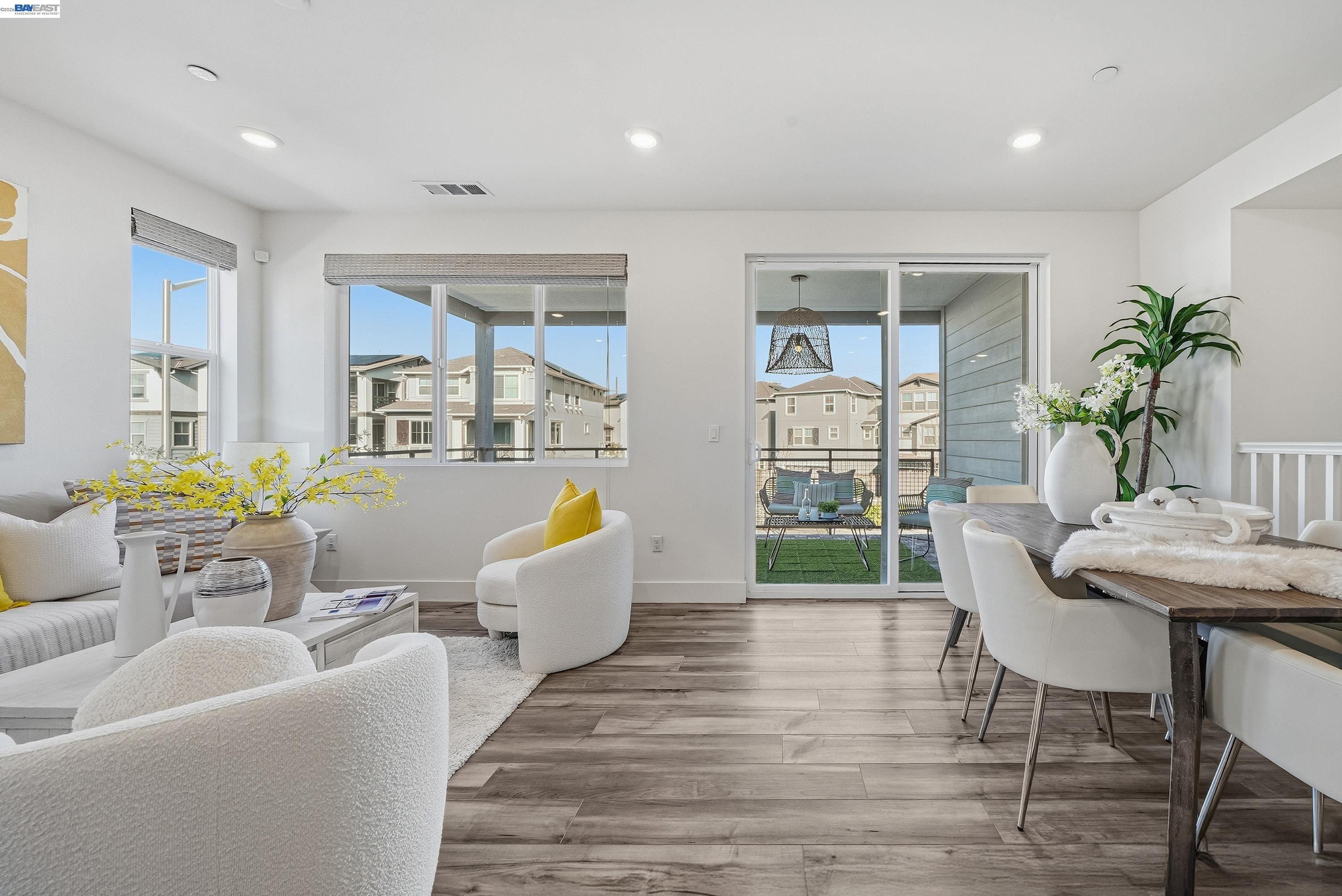 9620 Seawind Way Newark, CA 94560 - Photo 5 of 55 a living room with furniture a large window and wooden floor