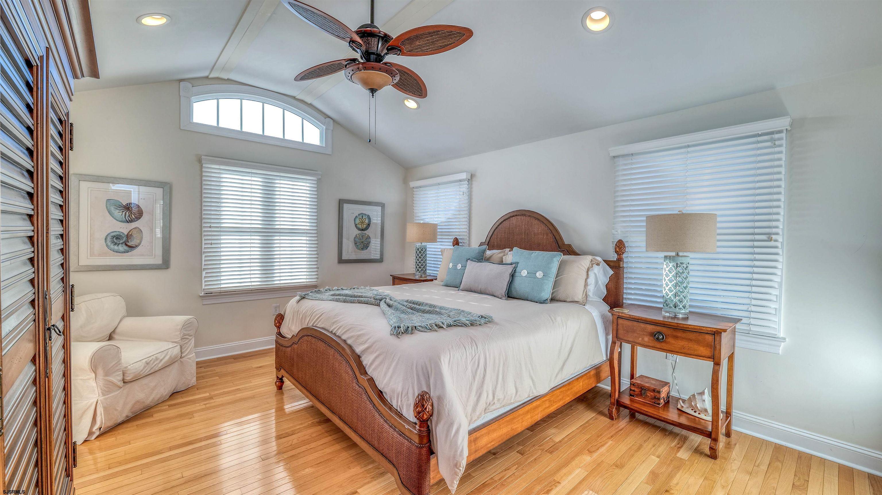 119 North Belmont Avenue, Unit AUGUST LABOR DAY Margate City, NJ 08402 - Photo 16 of 35 a bedroom with a bed and a chandelier