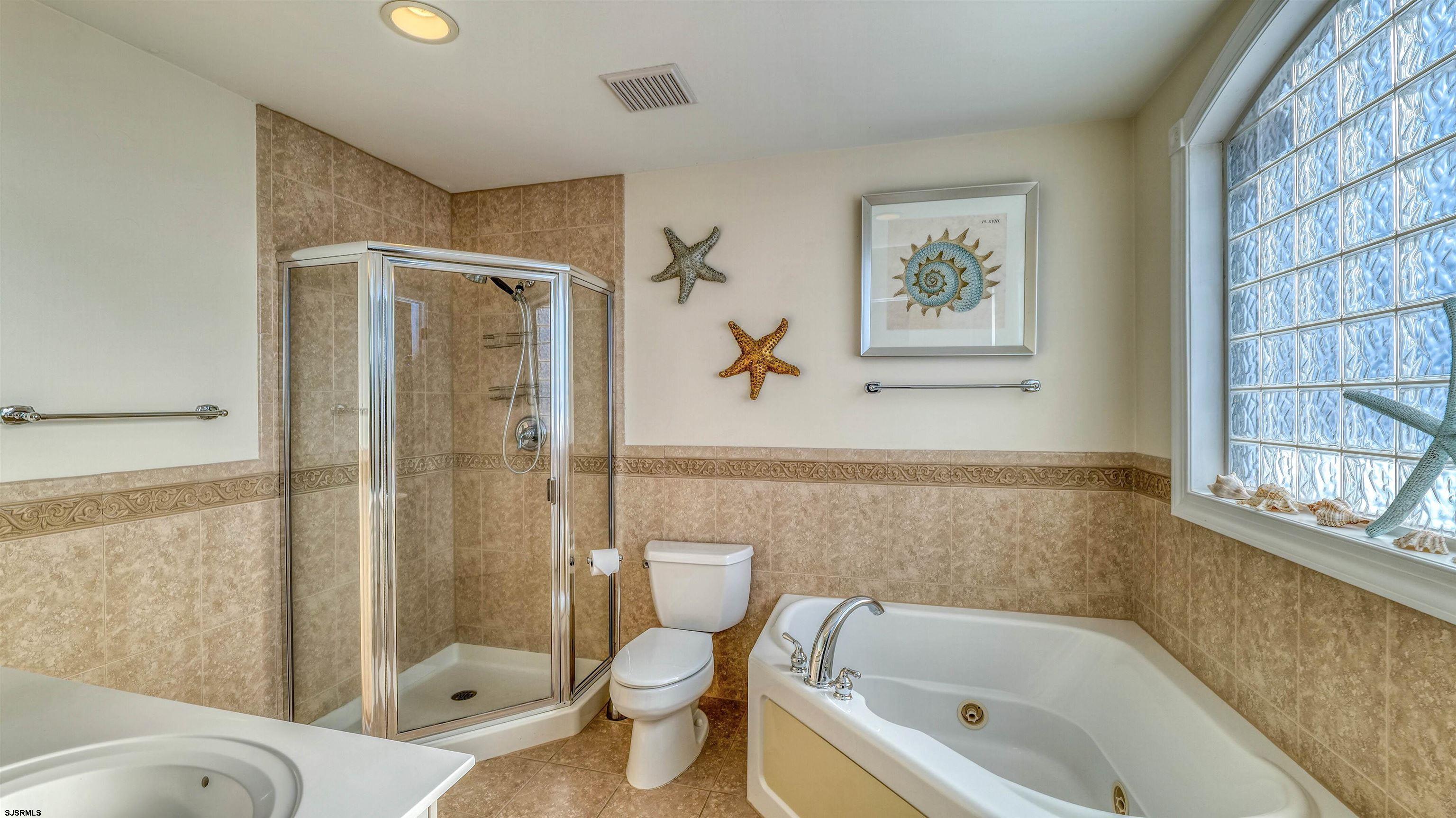119 North Belmont Avenue, Unit AUGUST LABOR DAY Margate City, NJ 08402 - Photo 19 of 35 a bathroom with a bathtub toilet and shower