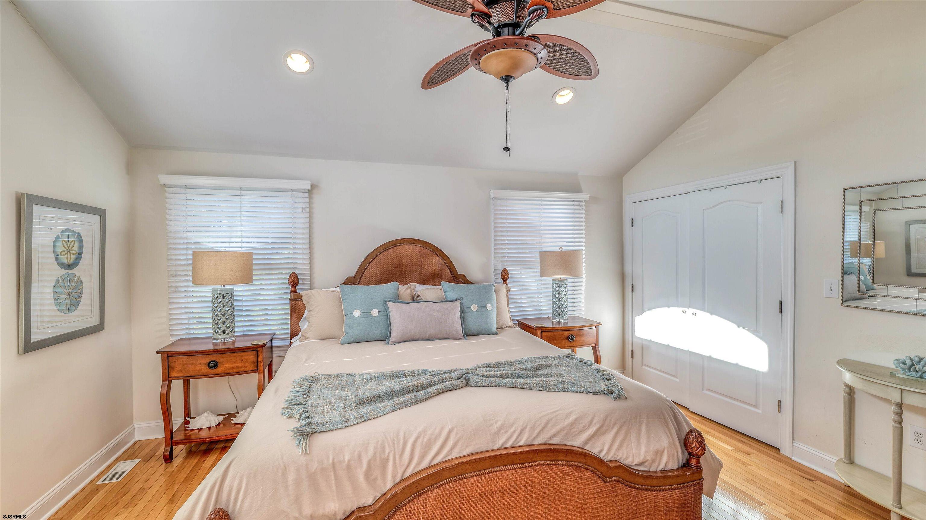 119 North Belmont Avenue, Unit AUGUST LABOR DAY Margate City, NJ 08402 - Photo 21 of 35 a bedroom with a bed and a chandelier