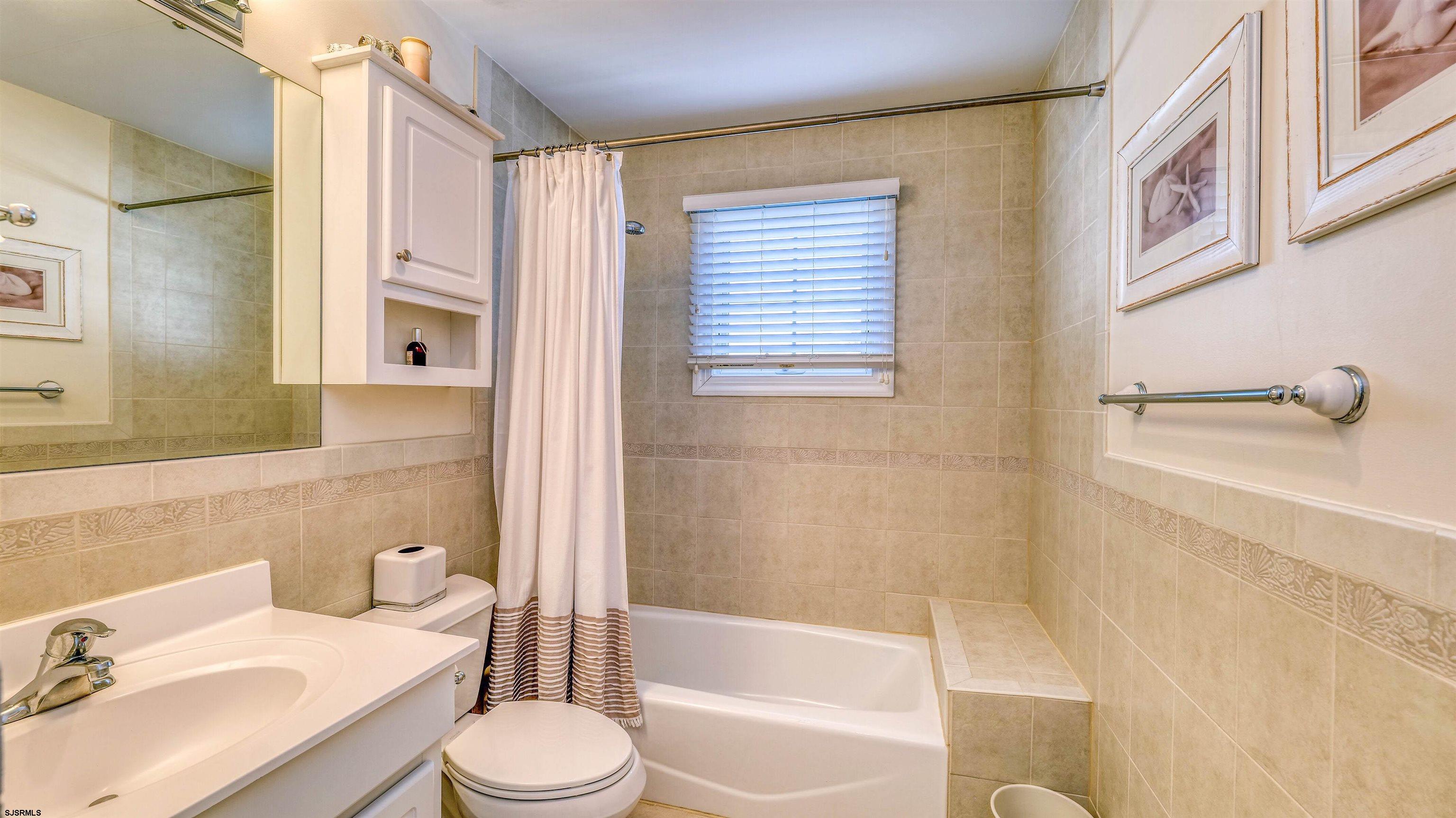 119 North Belmont Avenue, Unit AUGUST LABOR DAY Margate City, NJ 08402 - Photo 23 of 35 a bathroom with a sink toilet and shower