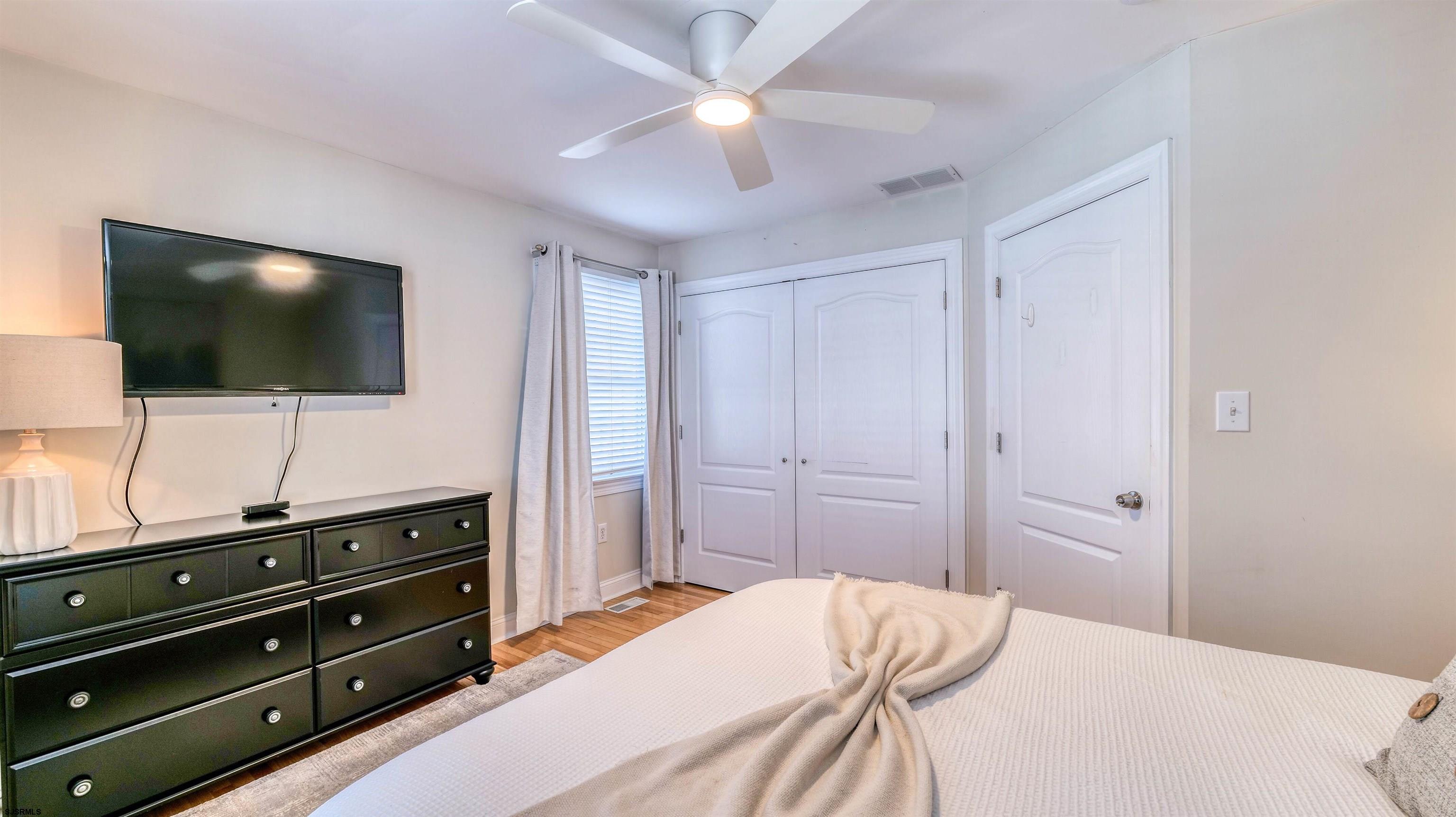 119 North Belmont Avenue, Unit AUGUST LABOR DAY Margate City, NJ 08402 - Photo 25 of 35 a bedroom with a bed and a flat screen tv