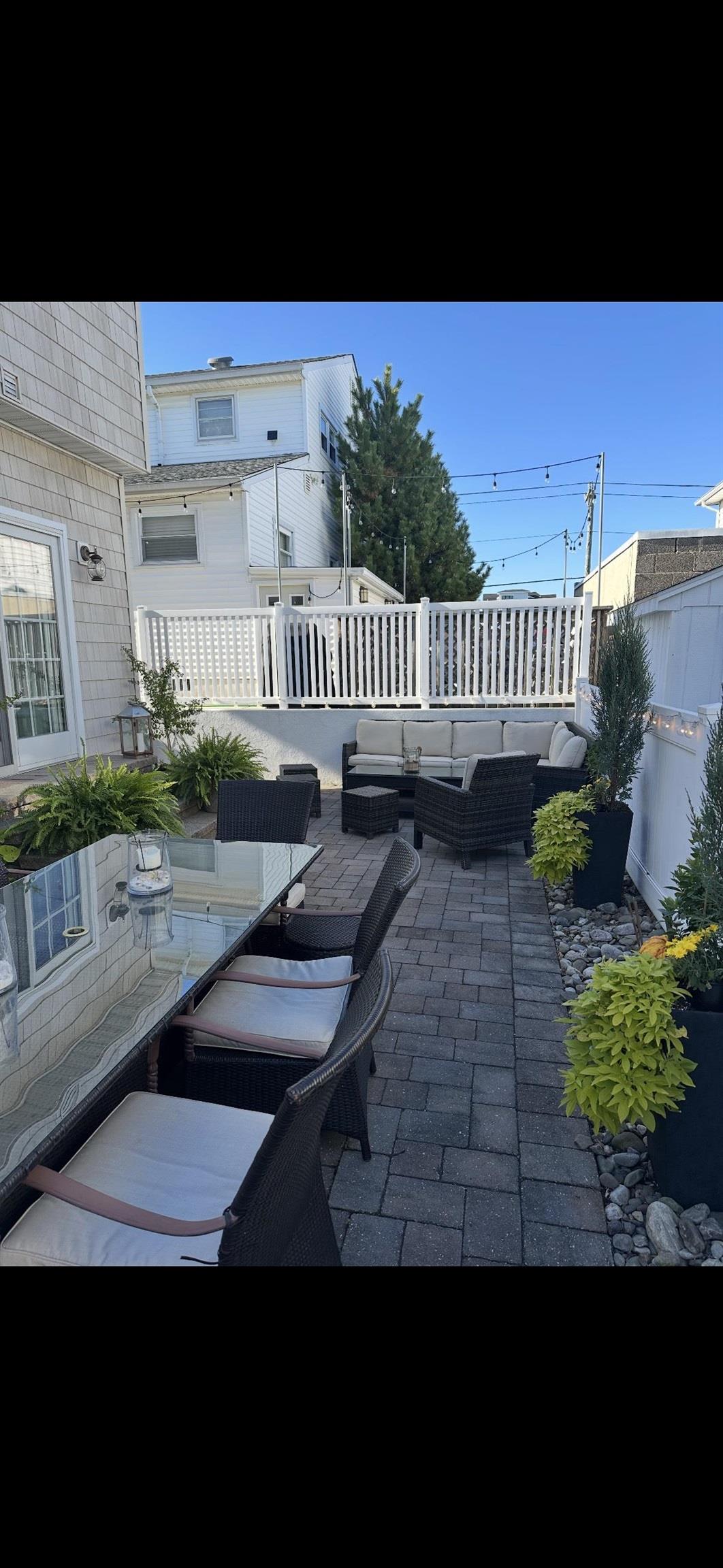 119 North Belmont Avenue, Unit AUGUST LABOR DAY Margate City, NJ 08402 - Photo 29 of 35 a view of a back yard of the house and a yard