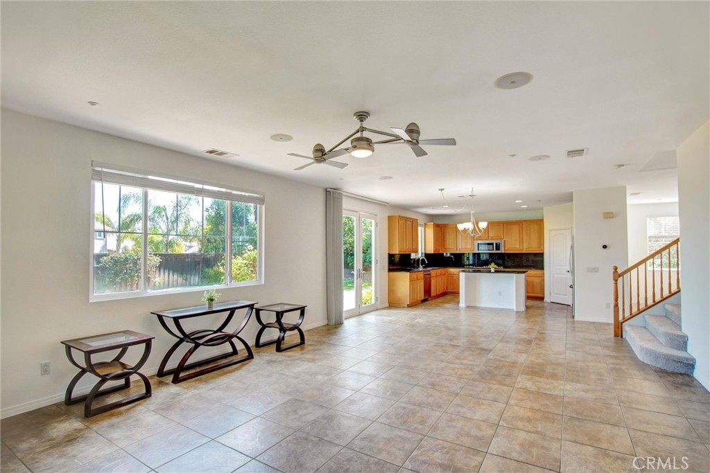 9350 Dauchy Avenue Riverside, CA 92508 - Photo 14 of 34 Experience the ultimate open-concept layout. The seamless flow from the kitchen to the sun-drenched family room creates an airy, expansive atmosphere highlighted by recessed lighting and views of the lush backyard.