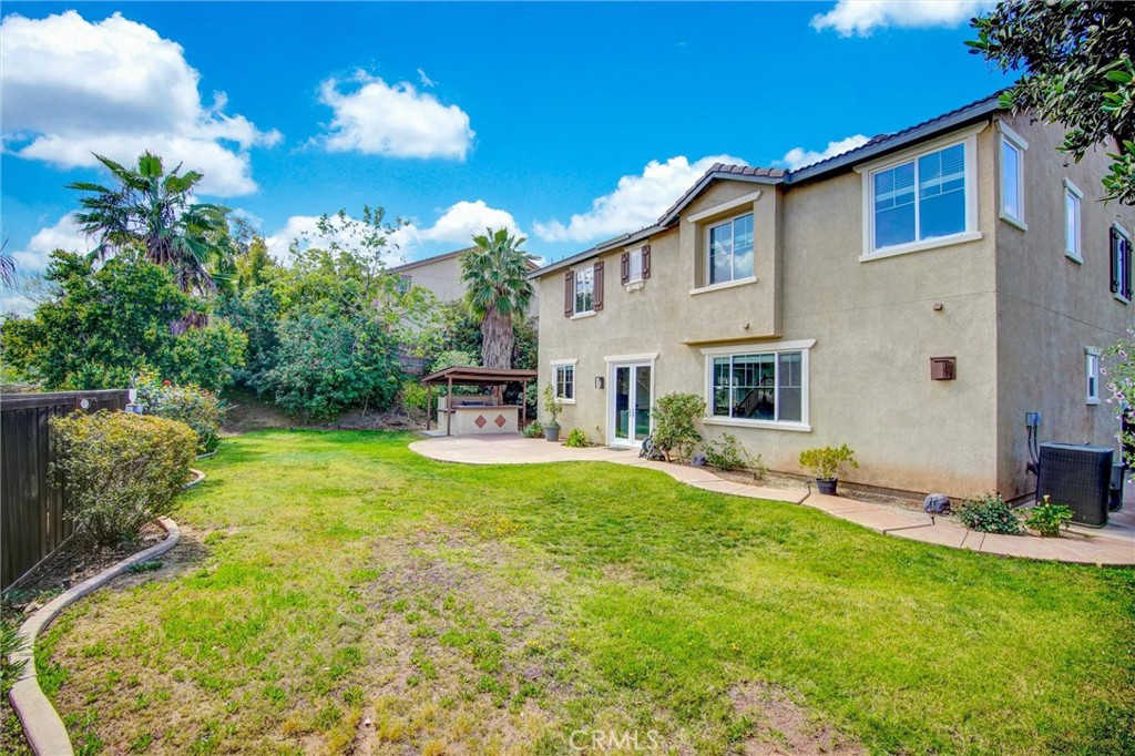 9350 Dauchy Avenue Riverside, CA 92508 - Photo 5 of 34 Your private Riverside retreat. This oversized lot features a manicured lawn, a built-in BBQ station, and plenty of space for a future pool or garden—all with the added benefit of no rear neighbors for ultimate privacy.