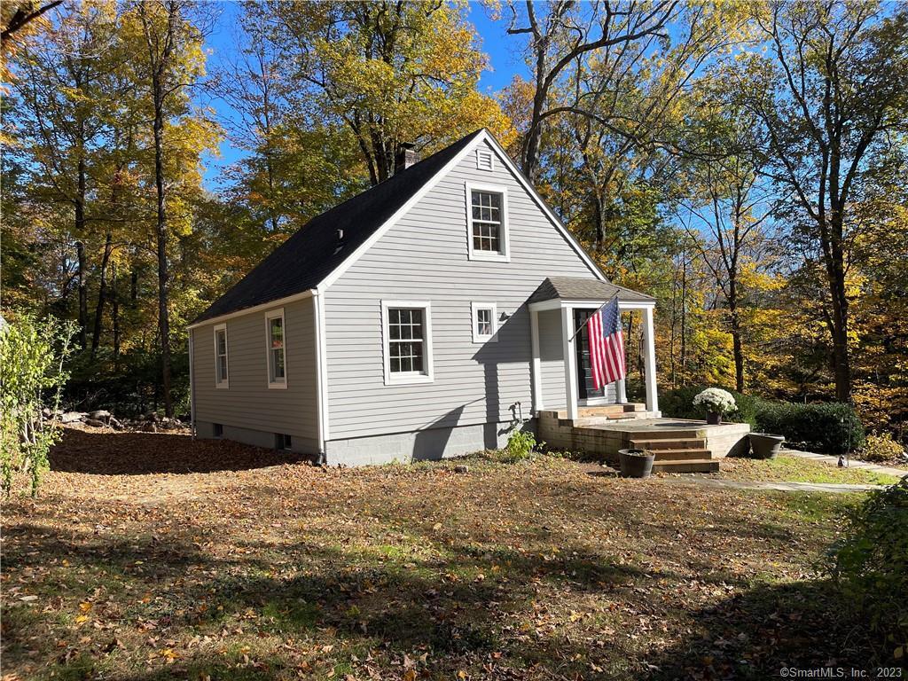 72 Kent Road Wilton, CT 06897 - Photo 1 of 1 a front view of house with yard and trees around