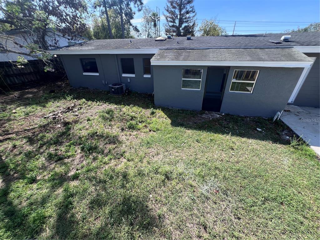 3823 Pine Ridge Road Orlando, FL 32808 - Photo 12 of 13 a view of a house with a yard