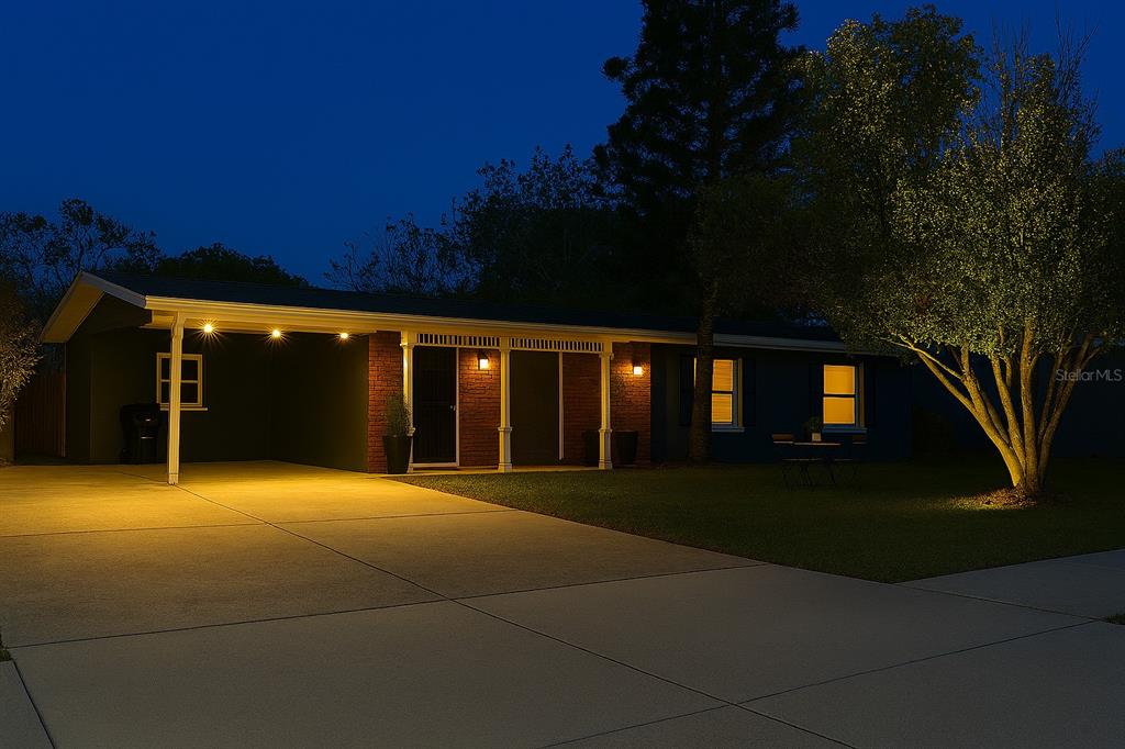 3823 Pine Ridge Road Orlando, FL 32808 - Photo 13 of 13 a view of an chairs under an umbrella in front of house