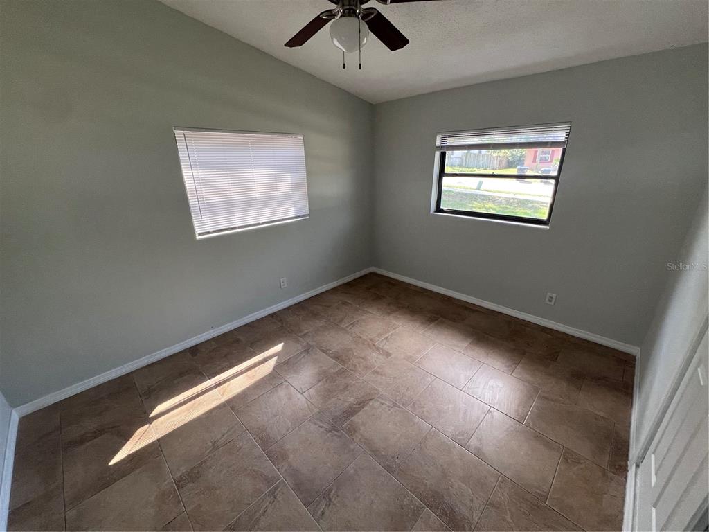 3823 Pine Ridge Road Orlando, FL 32808 - Photo 8 of 13 a view of room with window and ceiling fan
