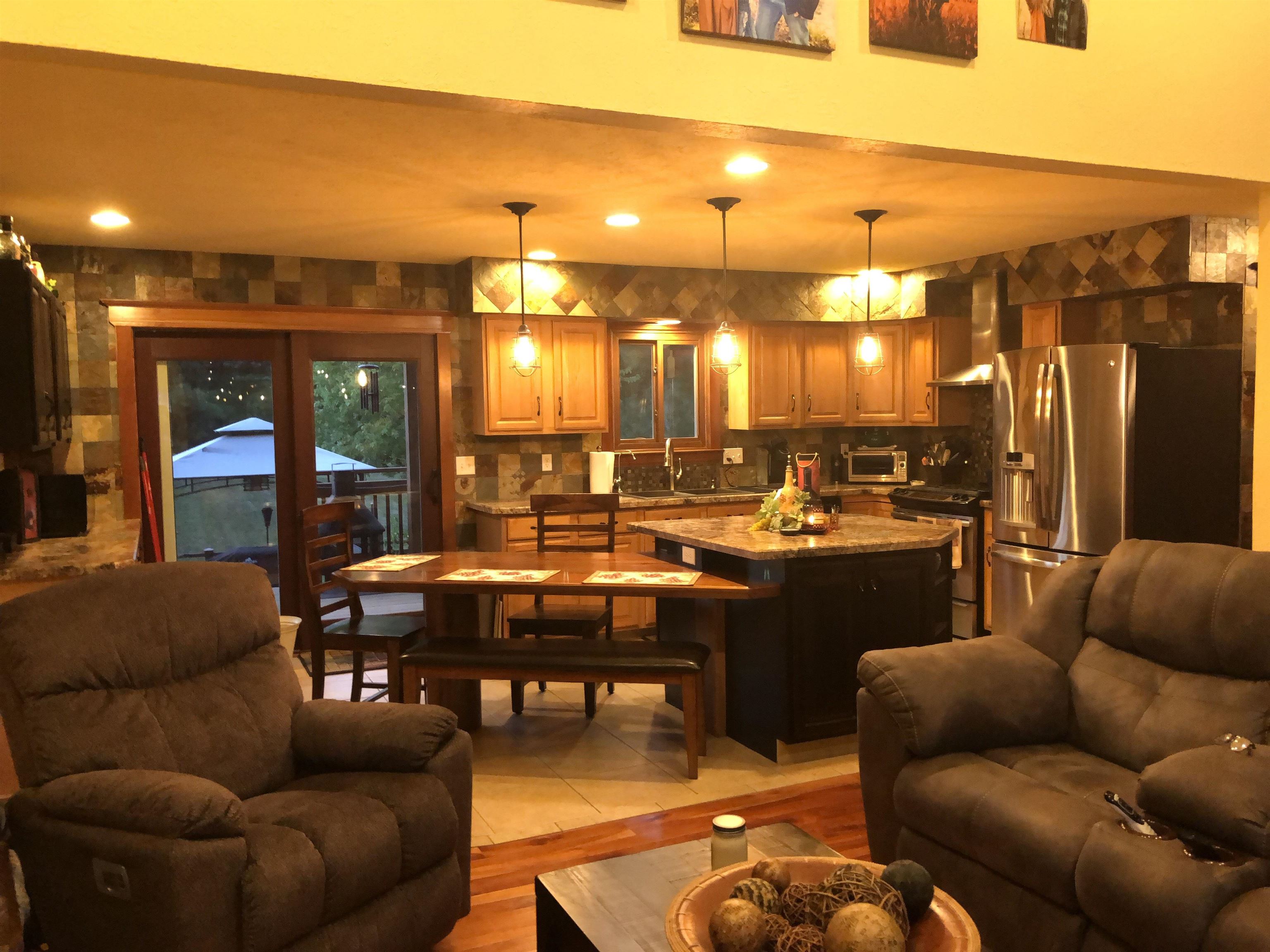 171 Lake Summerset Road Davis, IL 61019 - Photo 3 of 11 a living room with couches a coffee table and kitchen view