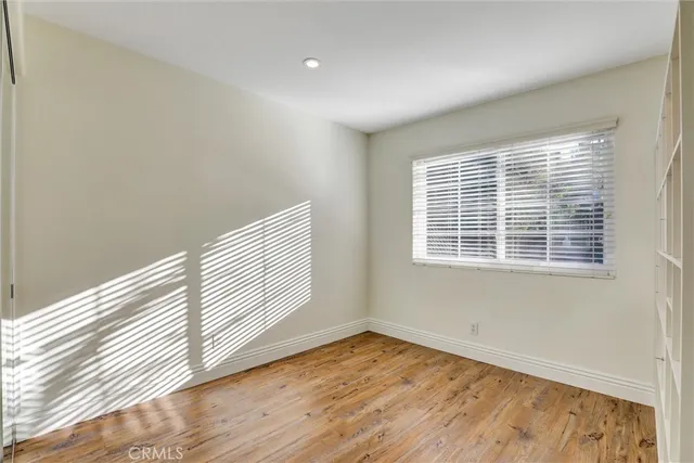 a view of a room with wooden floor and windows