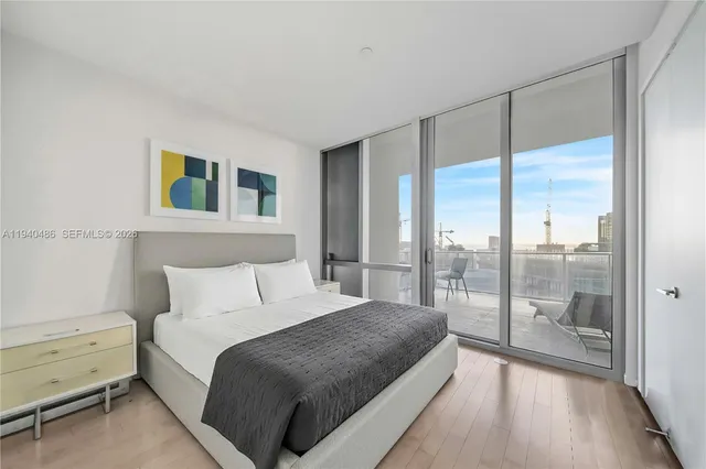 a bedroom with a large bed and a large window