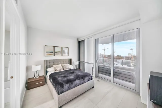 a bedroom with a large bed and a tv