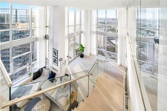 a view of an entryway with wooden floor and windows