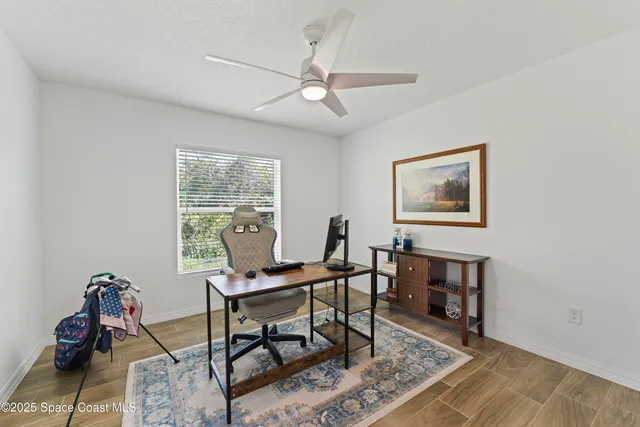 a workspace with wooden floor and a rug