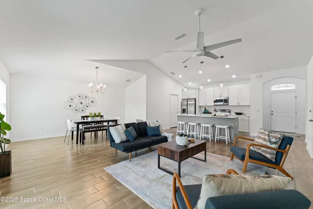 a living room with furniture and kitchen view