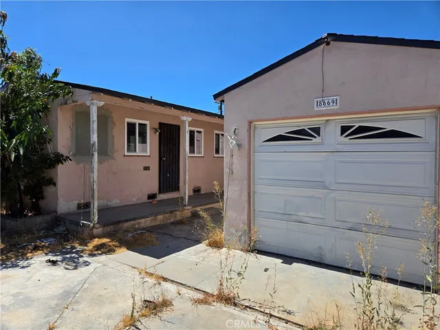 a front view of a house with parking area