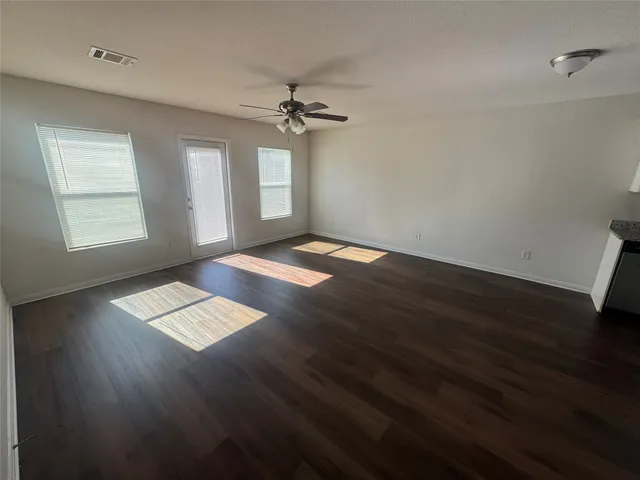 a view of wooden floor and windows in a room
