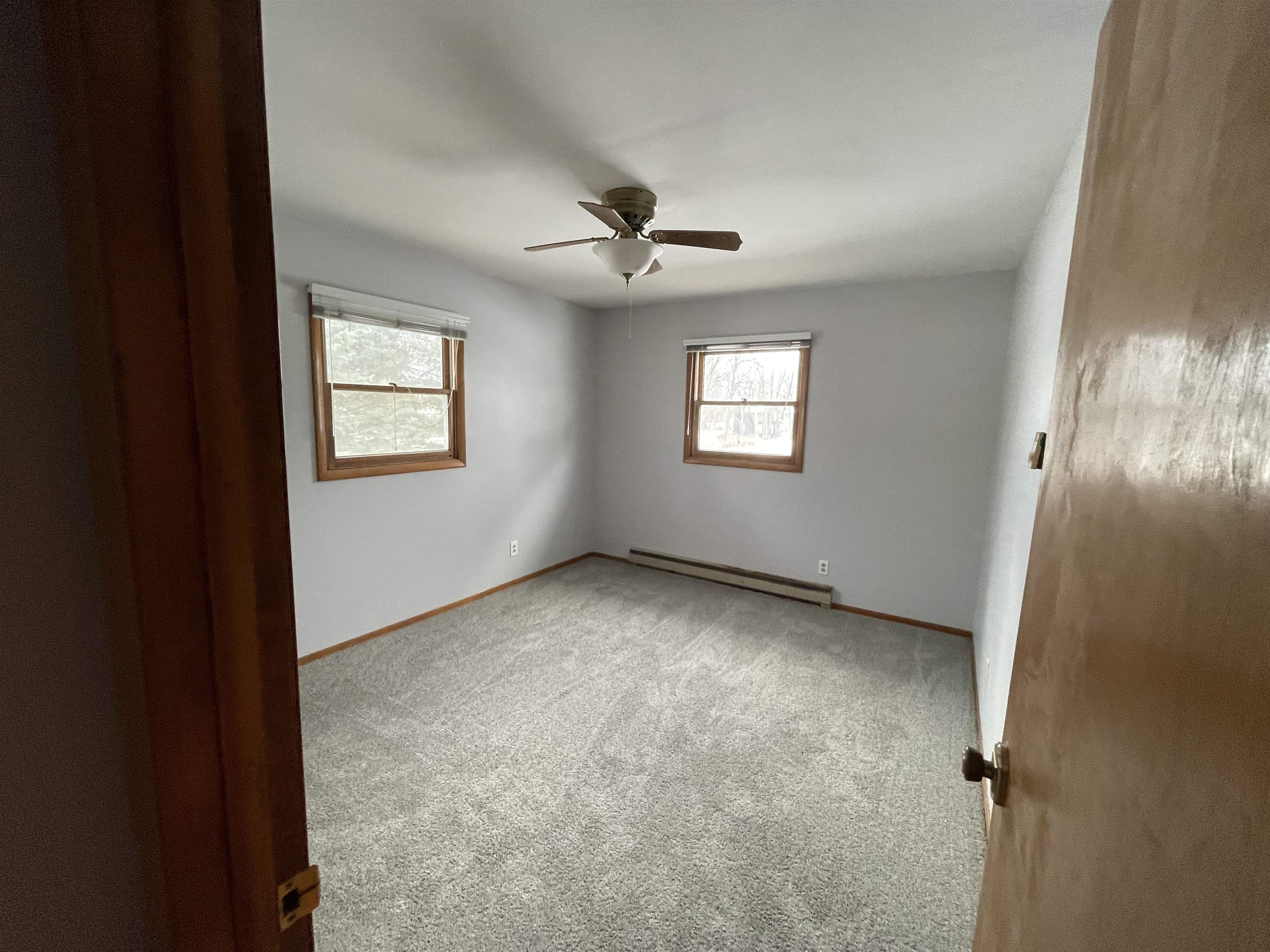 7870 Freeport Road Rockton, IL 61072 - Photo 15 of 22 an empty room with windows and fan