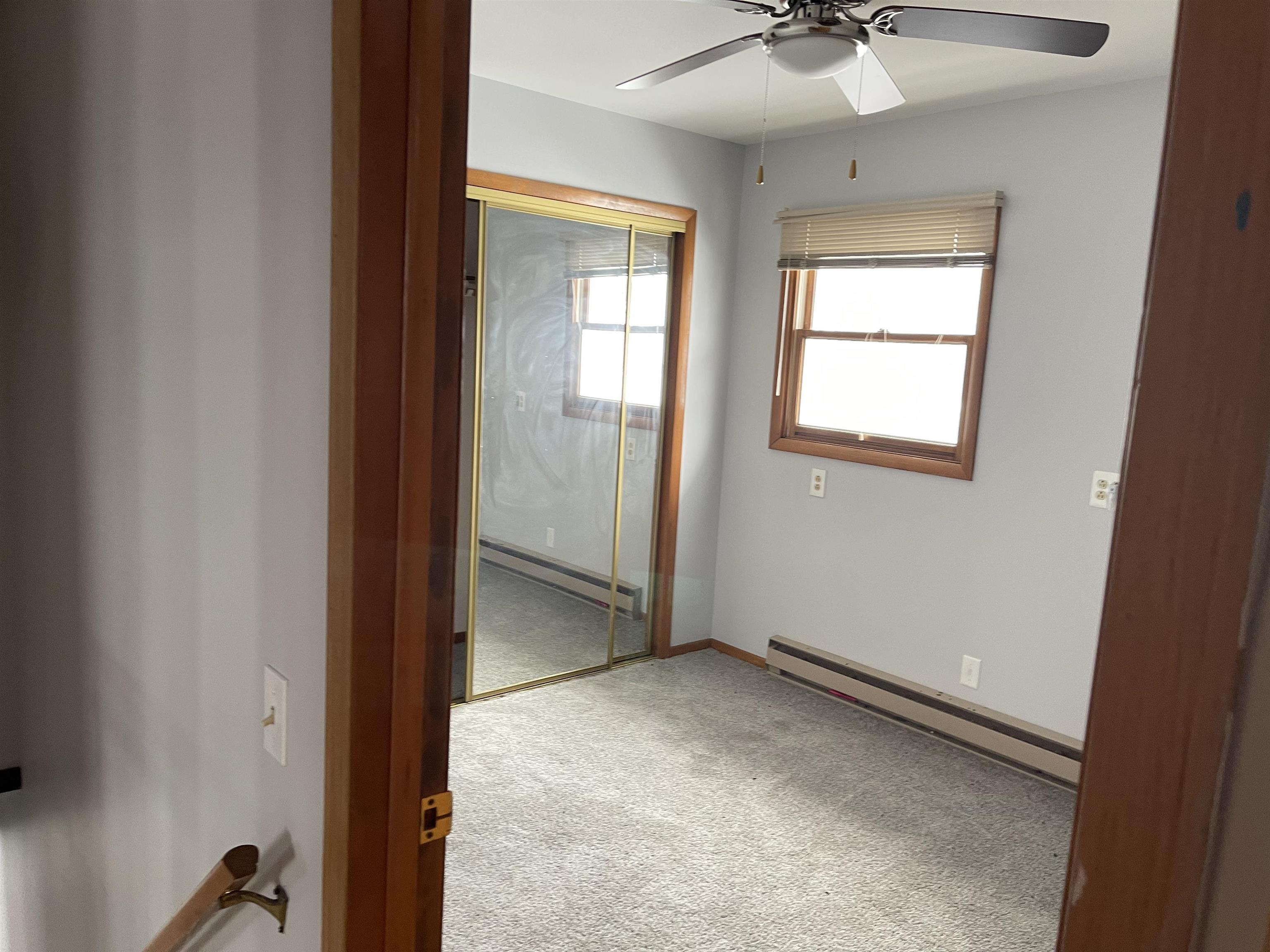 7870 Freeport Road Rockton, IL 61072 - Photo 17 of 22 wooden floor and window in an empty room