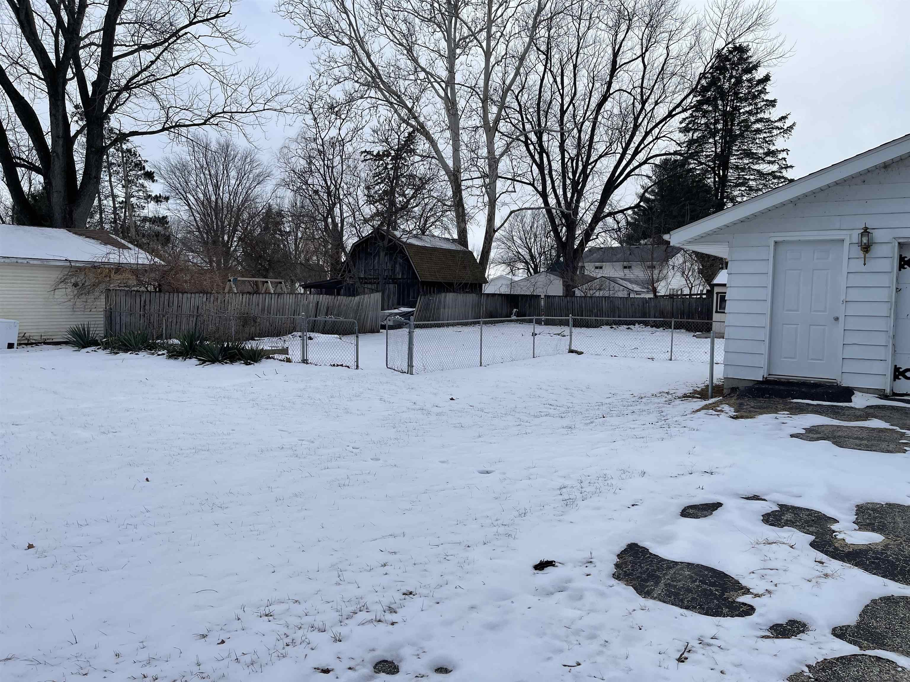 7870 Freeport Road Rockton, IL 61072 - Photo 19 of 22 a view of house with a yard covered in snow