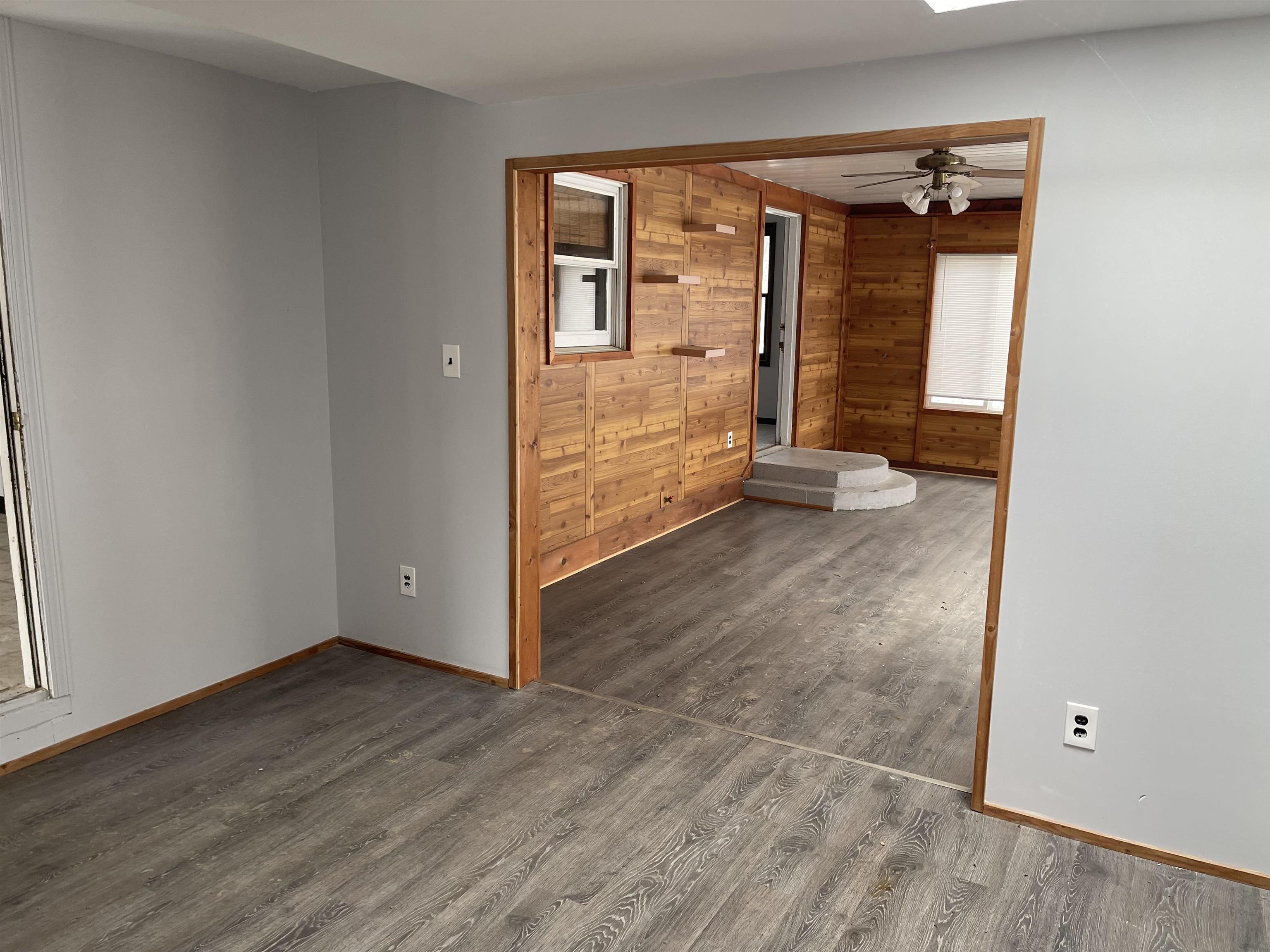 7870 Freeport Road Rockton, IL 61072 - Photo 3 of 22 an empty room with wooden floor and windows