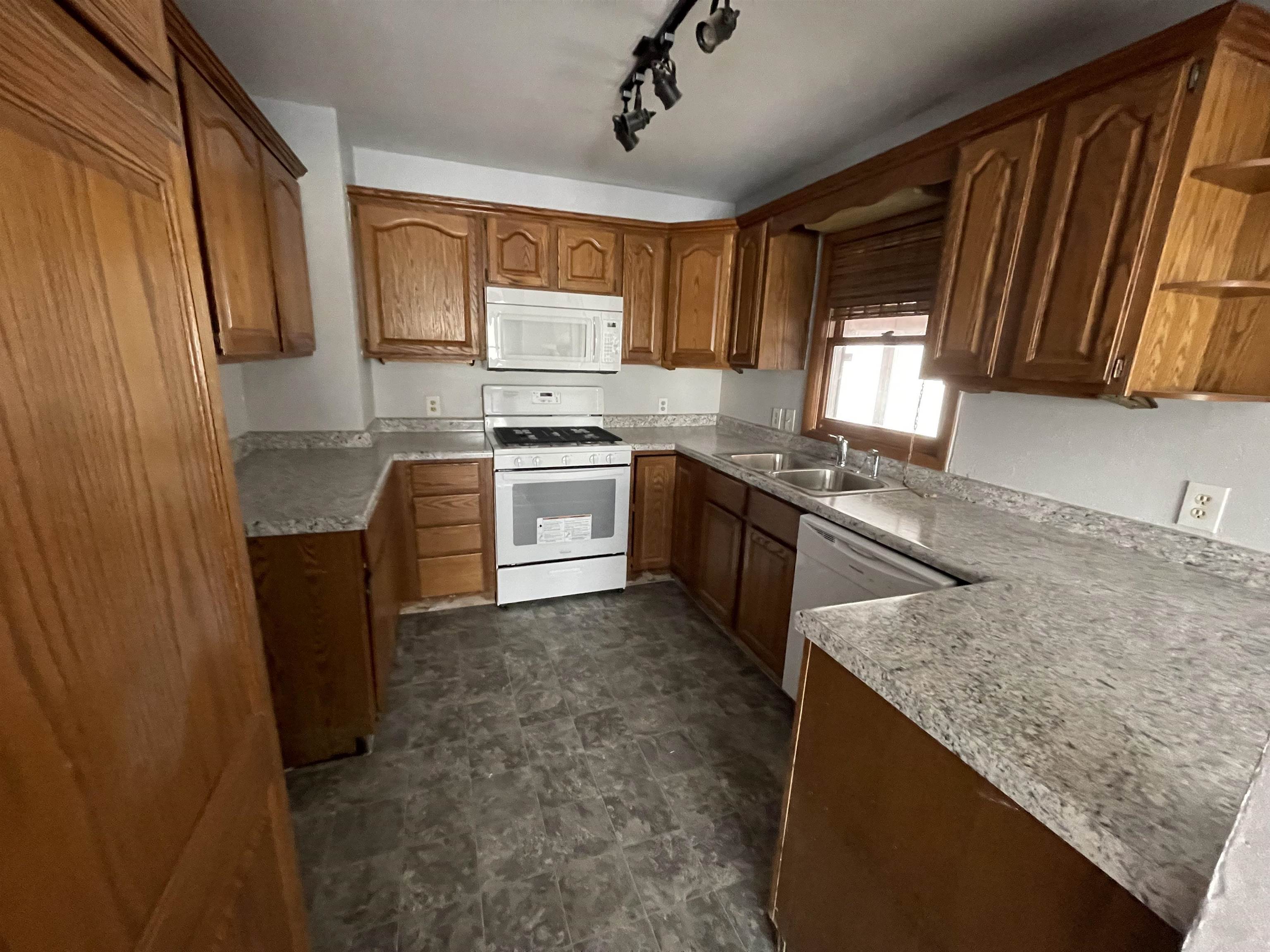 7870 Freeport Road Rockton, IL 61072 - Photo 5 of 22 a kitchen with stainless steel appliances granite countertop a sink stove and refrigerator
