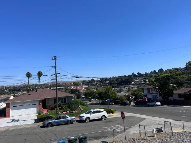 a view of a city street with cars