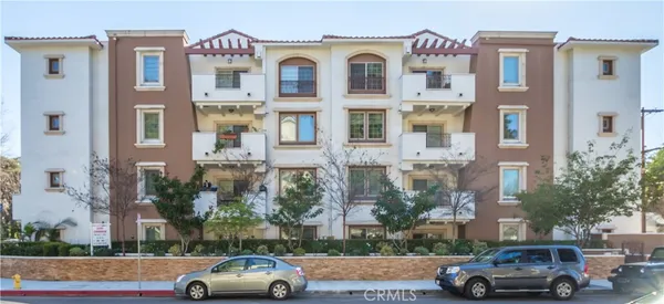 a front view of a residential apartment building with a yard